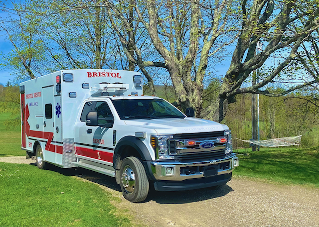 Ambulance on dirt road in the countryside.